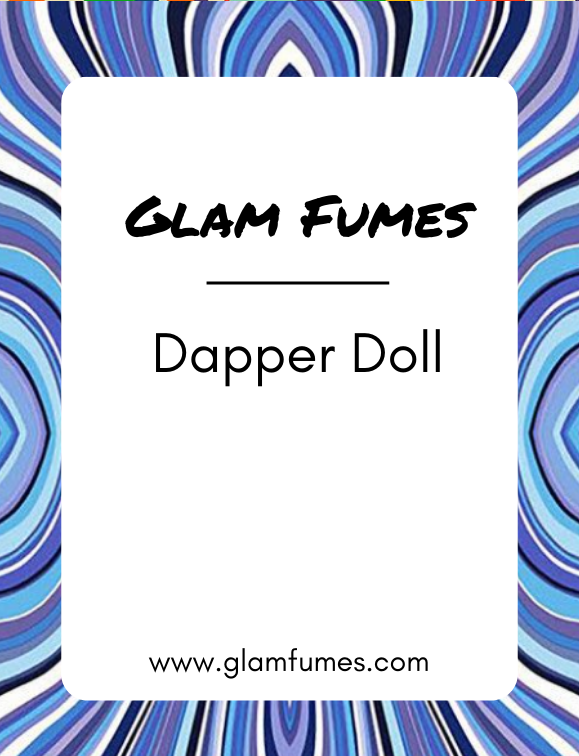 A bottle of perfume and body oil labeled 'Glam Fumes Dapper Doll' with a blue and purple striped pattern in the background.